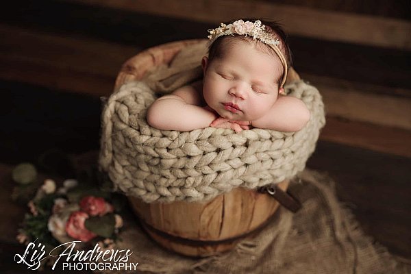 Baby girl in honey bucket prop